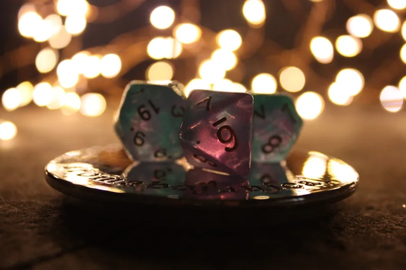 Dice sit on a platter with festive lights.